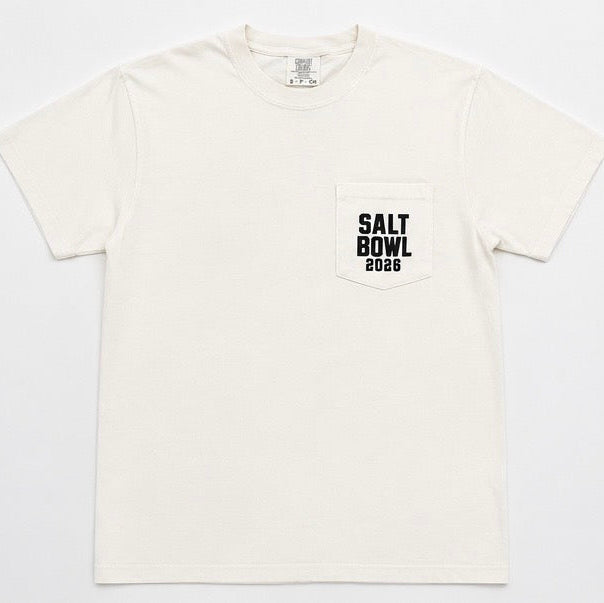 An off-white short-sleeve pocket t-shirt with a black printed 'SALT BOWL 2026' logo on the left chest pocket, displayed flat against a light gray background.