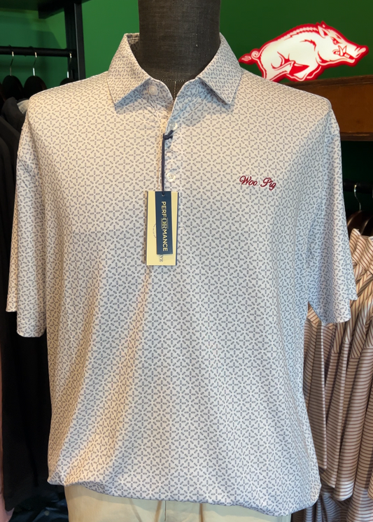 White patterned polo shirt on a mannequin with a tag, green background