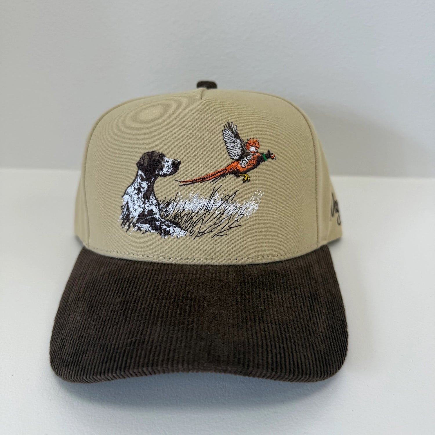 Cap with dog and bird design on a white background