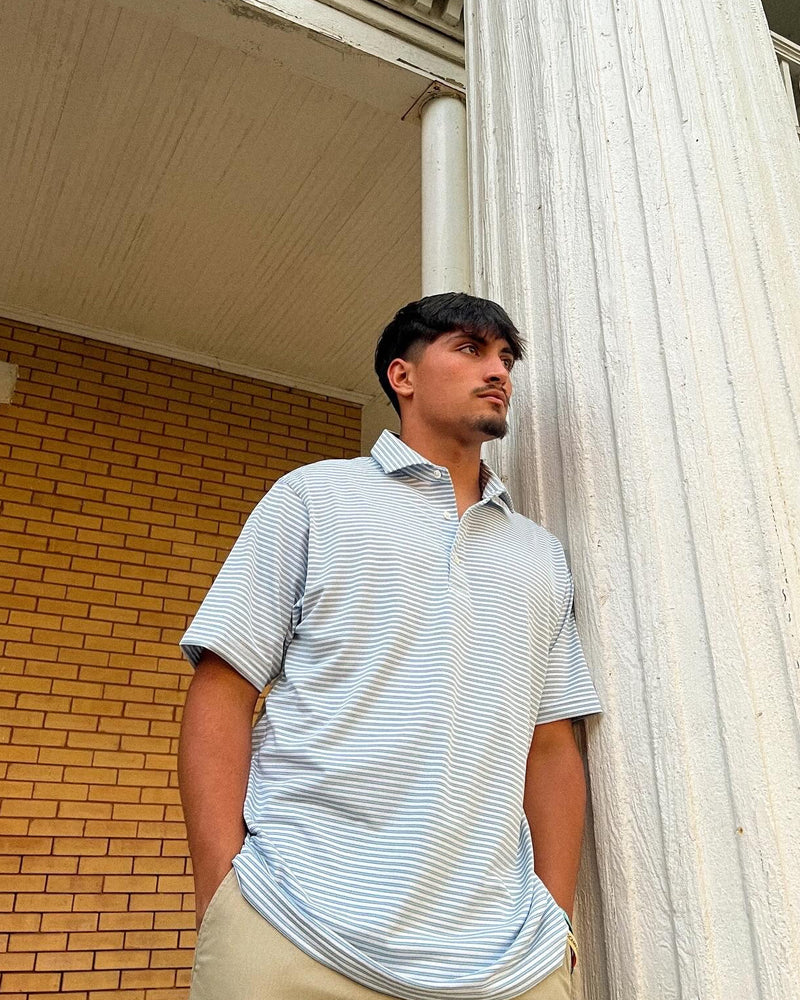 Man standing on a balcony with classical architecture